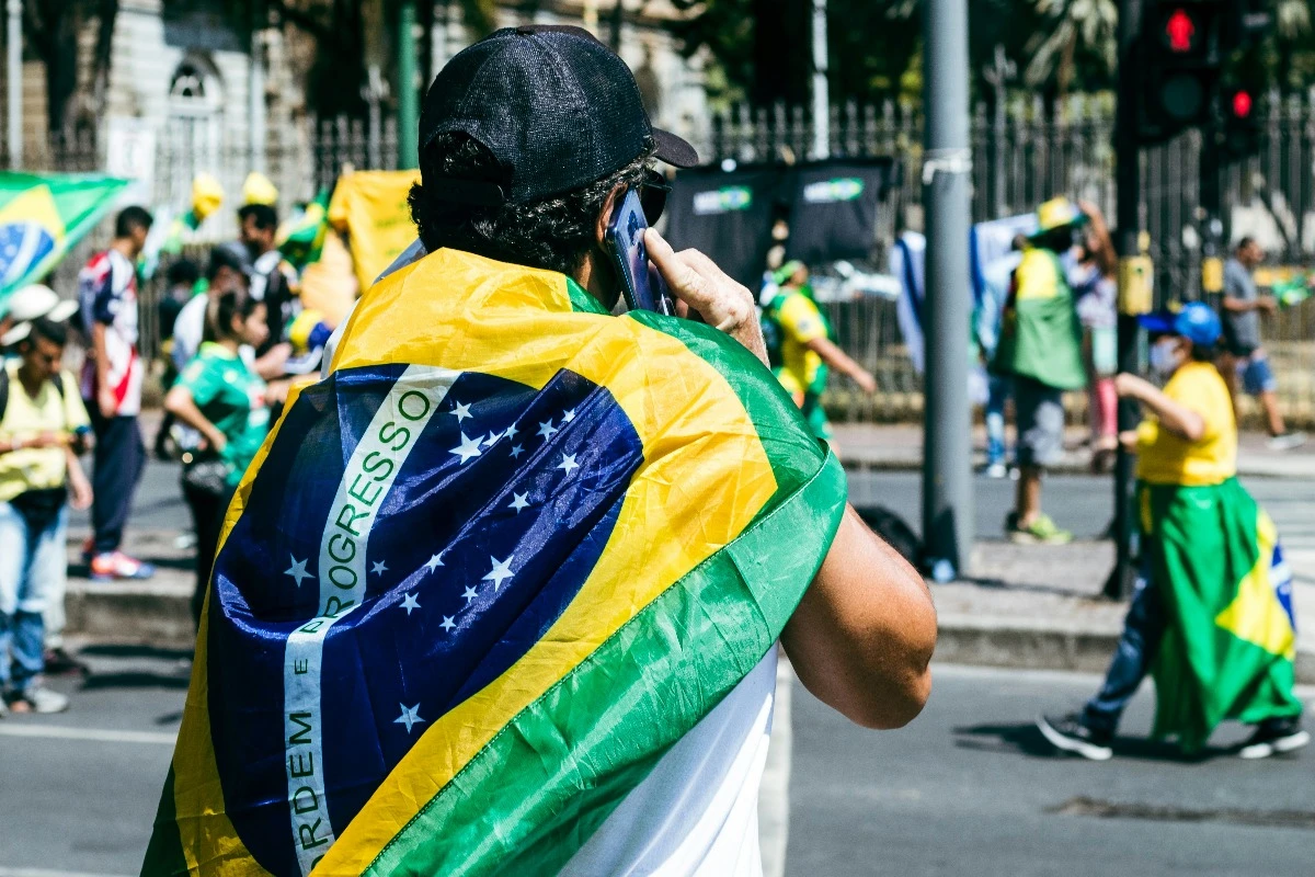 man wrapped brazilian flag