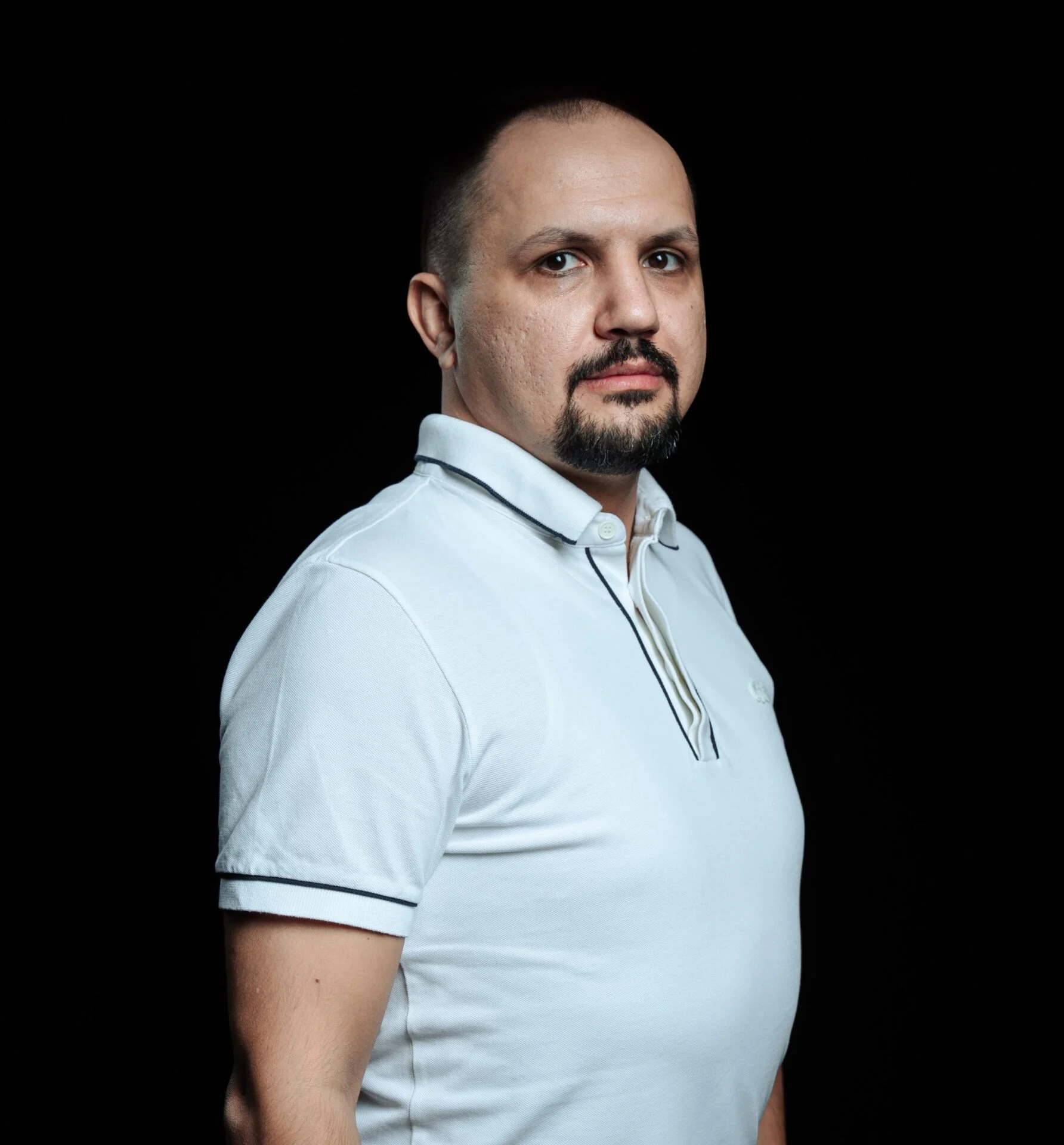 Portrait photo of DATA.BET CEO Yurii Berest in front of a black background